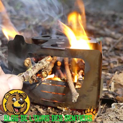 L'ouverture taillée dans l'une des parois du réchaud bushbox ultralight permet d'allimenter le foyer et le feu