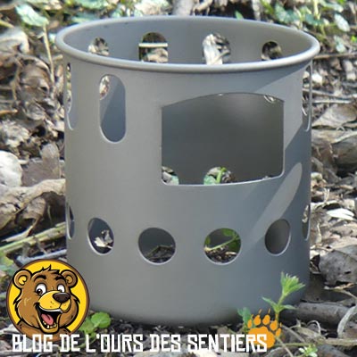 La partie haute du réchaud bois toaks en titane comporte des aérations ainsi qu'une fenêtre de ravitaillement en bois
